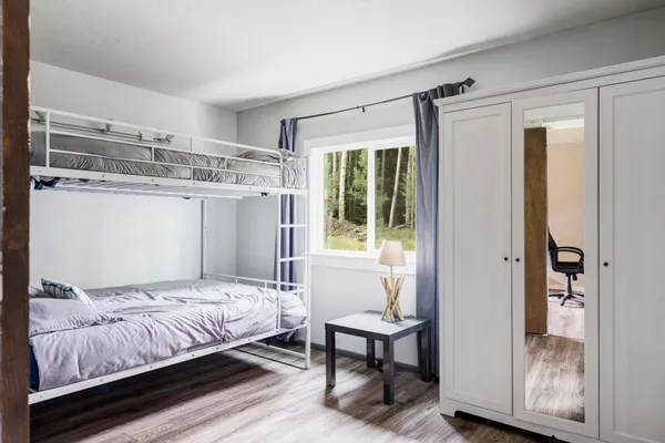 a bedroom with a bed and a window