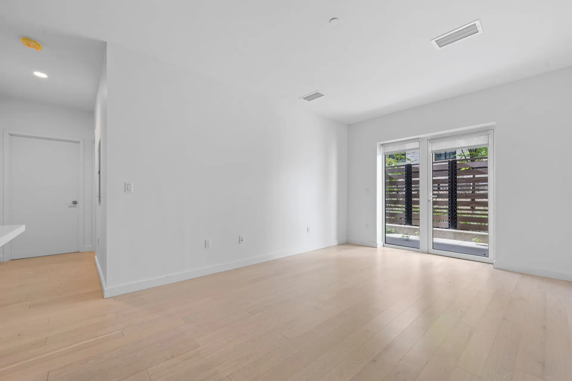 350 Clarkson Avenue, Unit 103 Brooklyn, NY 11226 - Photo 10 of 42 an empty room with wooden floor and windows
