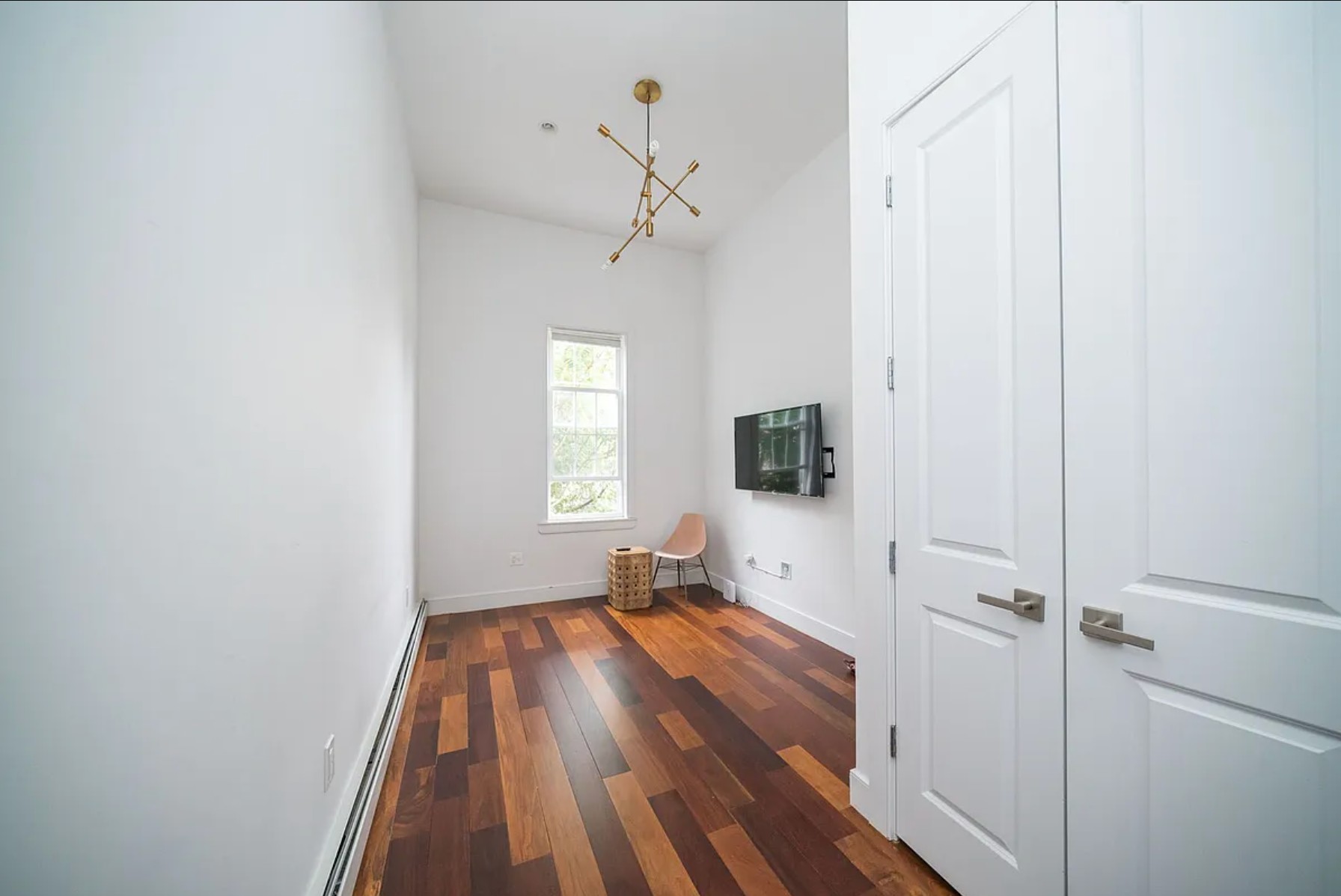 29 Melrose Street, Unit 2 Brooklyn, NY 11206 - Photo 8 of 13 a view of a room with wooden floor a ceiling fan and windows