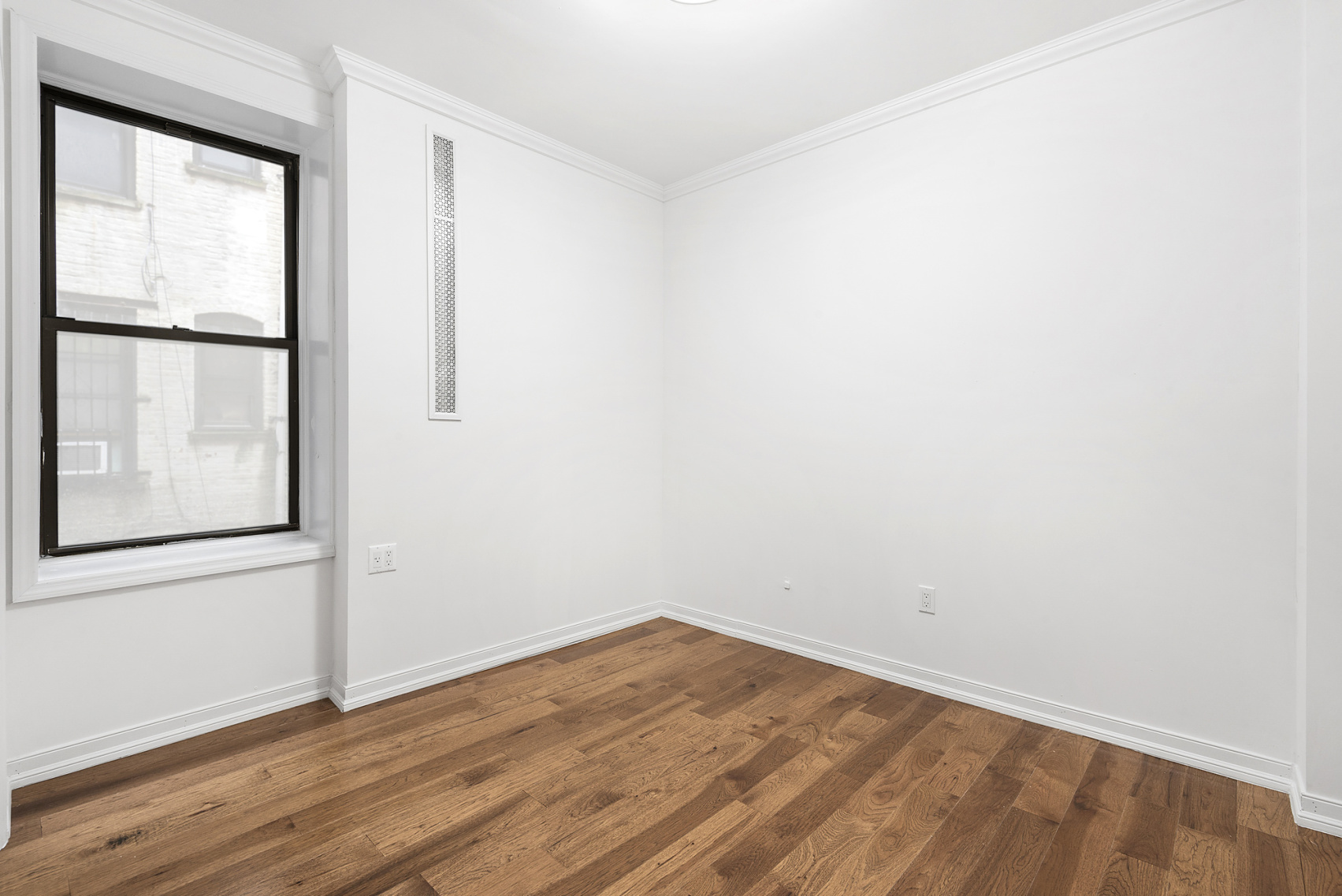 573 6th Street, Unit 1 Brooklyn, NY 11215 - Photo 7 of 10 an empty room with wooden floor and windows