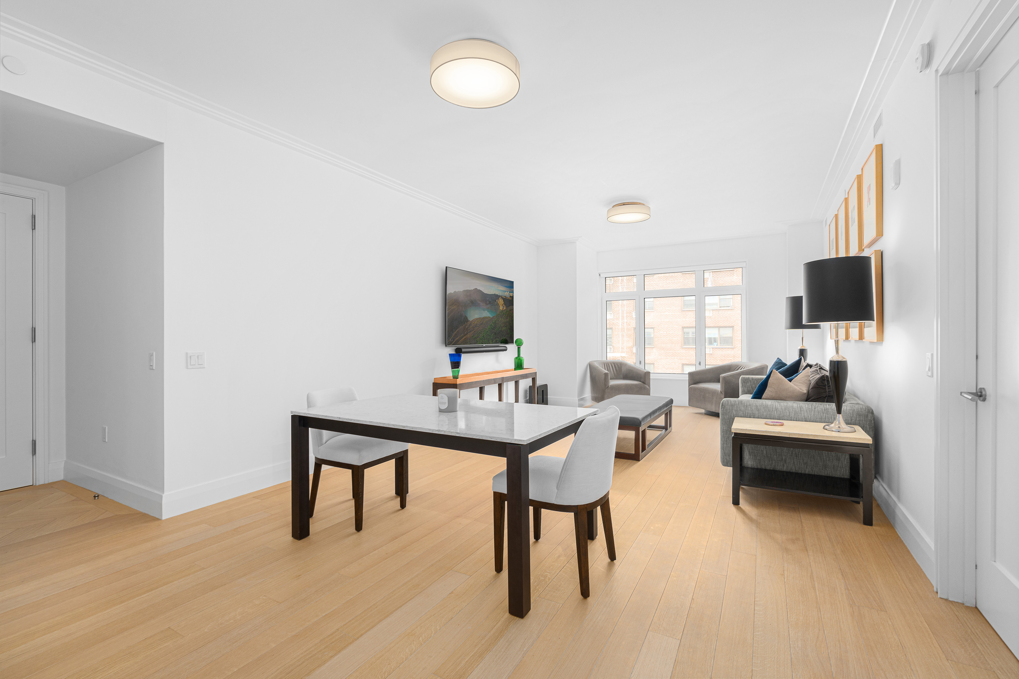 200 East 83rd Street, Unit 5D Manhattan, NY 10028 - Photo 4 of 29 a living room with furniture and a flat screen tv