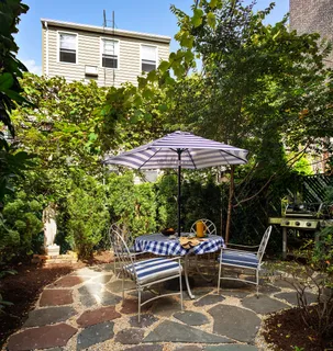 a view of backyard with outdoor seating and trees