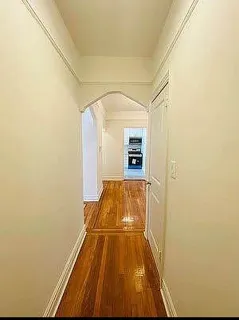 a view of hallway with wooden floor