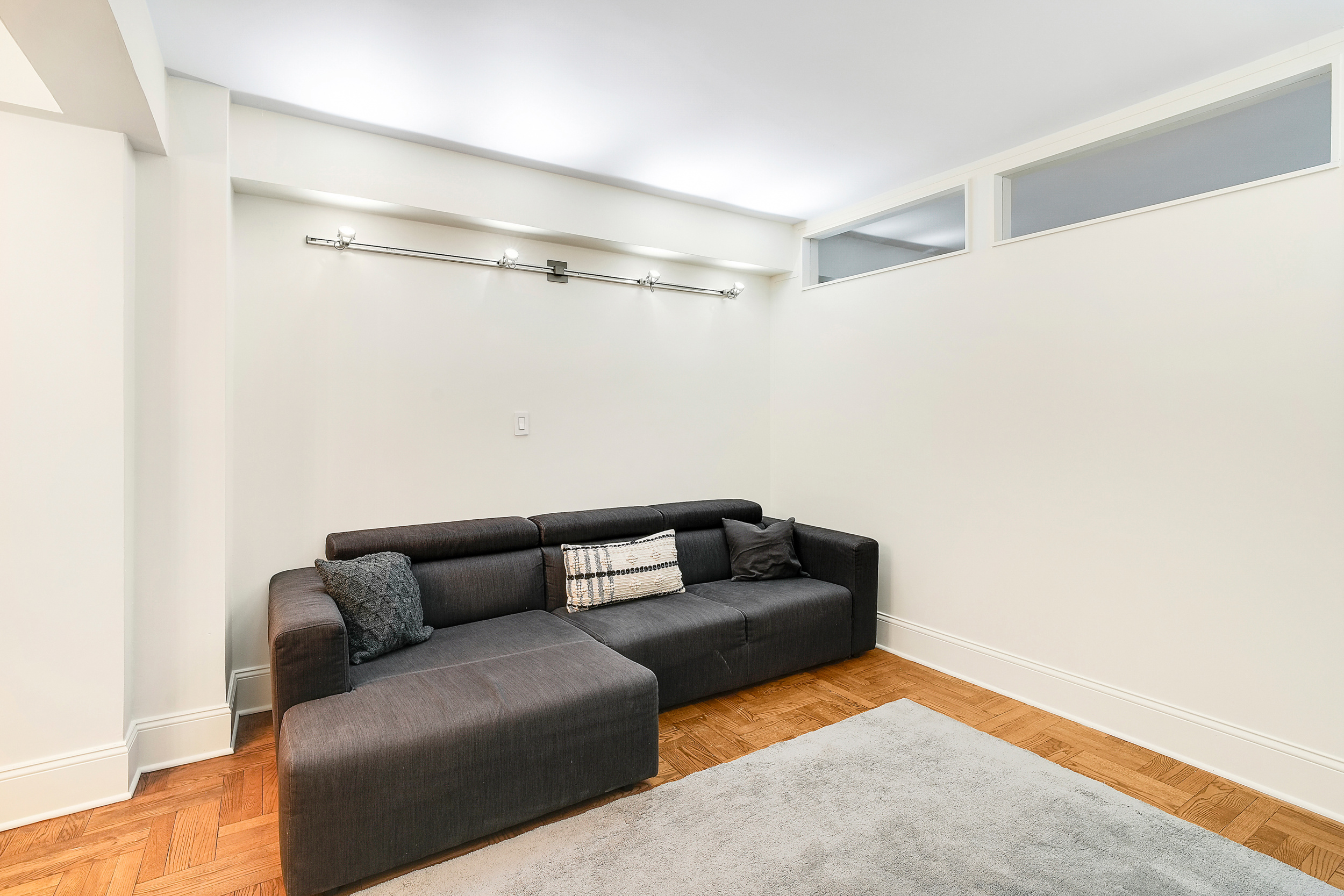 135 East 54th Street, Unit 12M Manhattan, NY 10022 - Photo 2 of 10 a living room with furniture and a rug