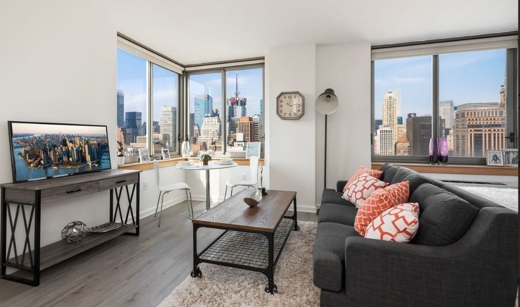 35 West 33rd Street, Unit 12A Manhattan, NY 10001 - Photo 2 of 28 a living room with furniture and a large window