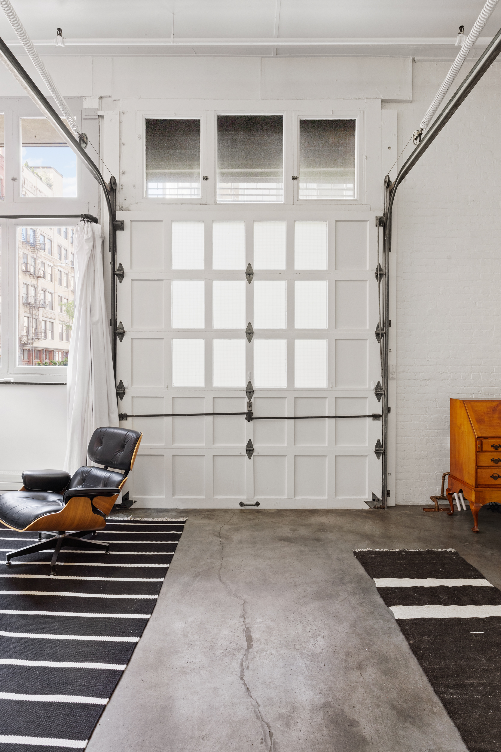 125 Watts Street, Unit 1 Manhattan, NY 10013 - Photo 3 of 24 a living room with a couch and a window