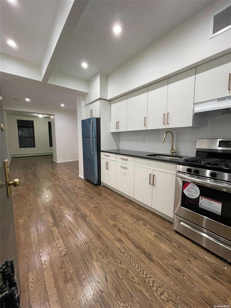 2049 2nd Avenue Manhattan, NY 10029 - Photo 9 of 18 a kitchen with a refrigerator and a stove top oven