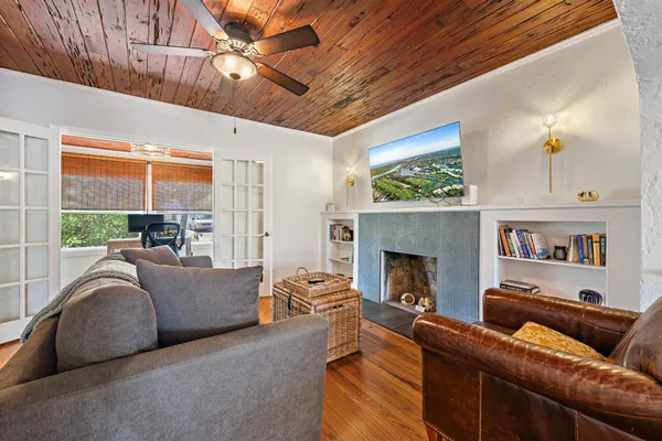 a living room with furniture a fireplace and a flat screen tv
