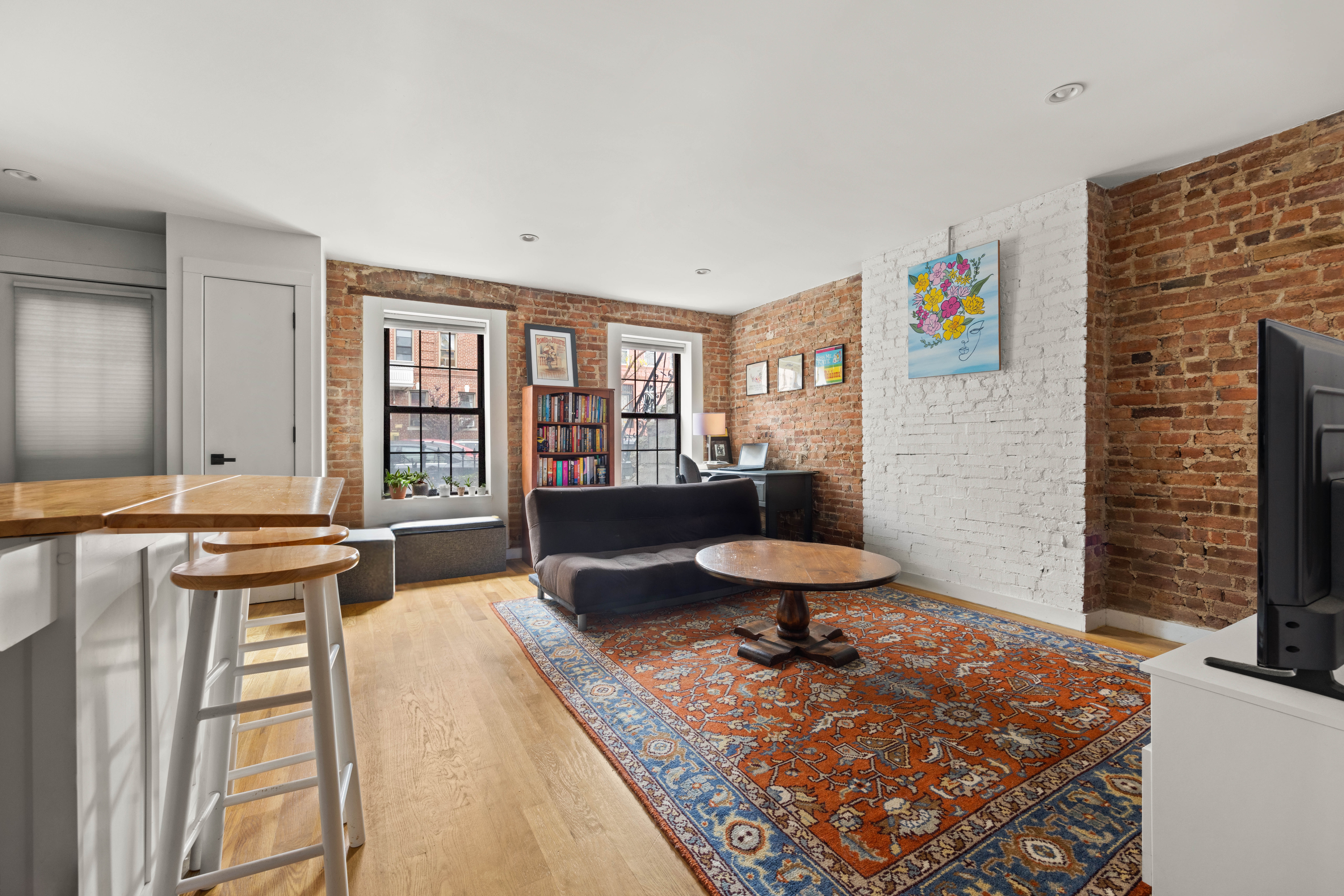 750 Lincoln Place Brooklyn, NY 11216 - Photo 20 of 24 a living room with a couch and a table