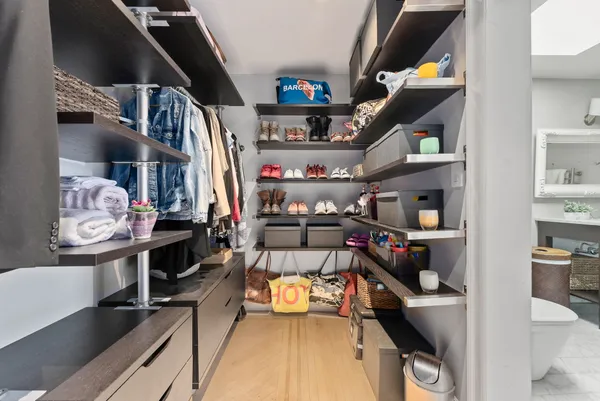 walk in closet with lots of small appliances