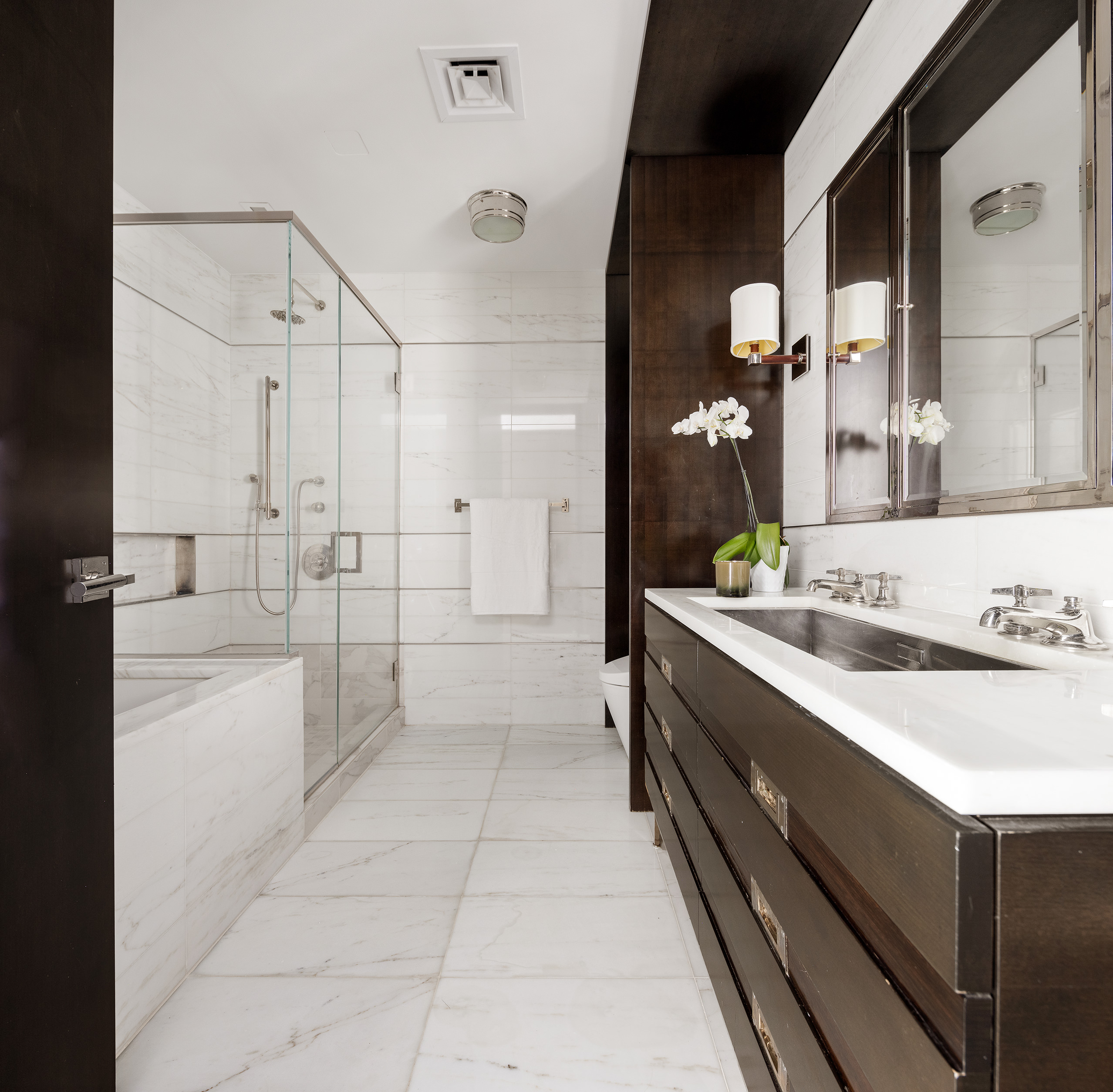 151 East 85th Street, Unit 14A Manhattan, NY 10028 - Photo 11 of 14 a spacious bathroom with a granite countertop sink mirror and bathtub