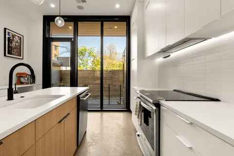a kitchen that has a sink and a stove