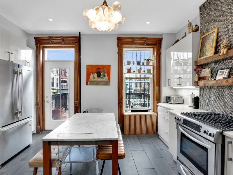 1124 Prospect Place, Unit PLEX Brooklyn, NY 11213 - Photo 4 of 15 a kitchen with stainless steel appliances granite countertop a stove a refrigerator a oven a sink with a dining table and chairs