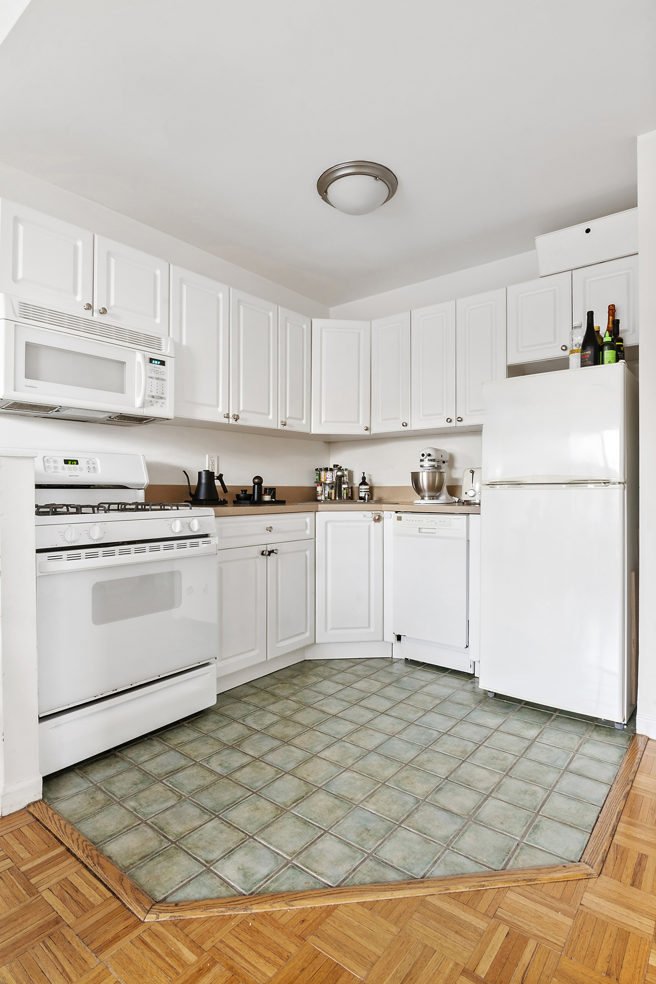129 Boerum Place, Unit 5D Brooklyn, NY 11201 - Photo 2 of 9 a kitchen with cabinets and white appliances