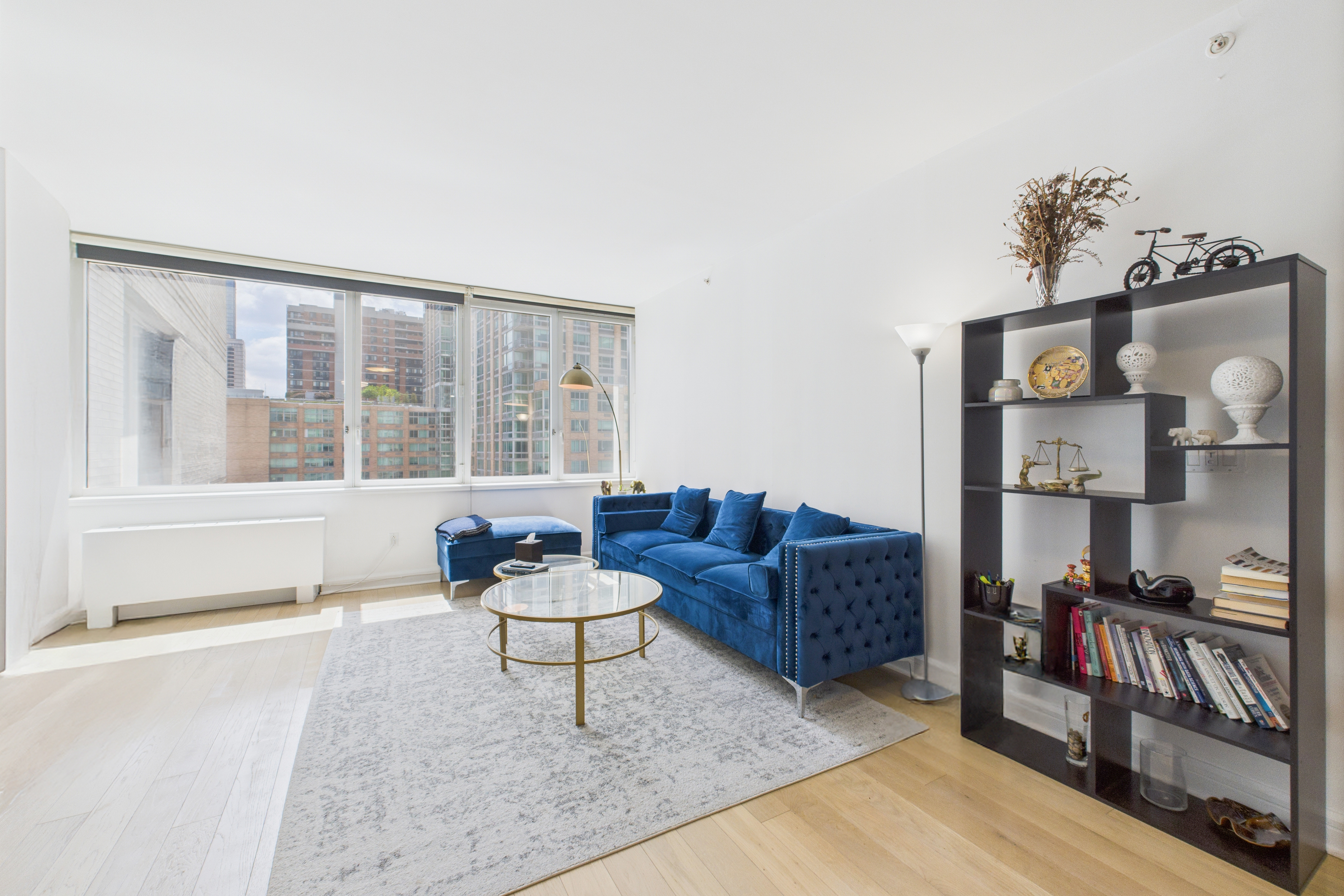 100 Riverside Boulevard, Unit 12B Manhattan, NY 10069 - Photo 2 of 10 a living room with furniture and a floor to ceiling window
