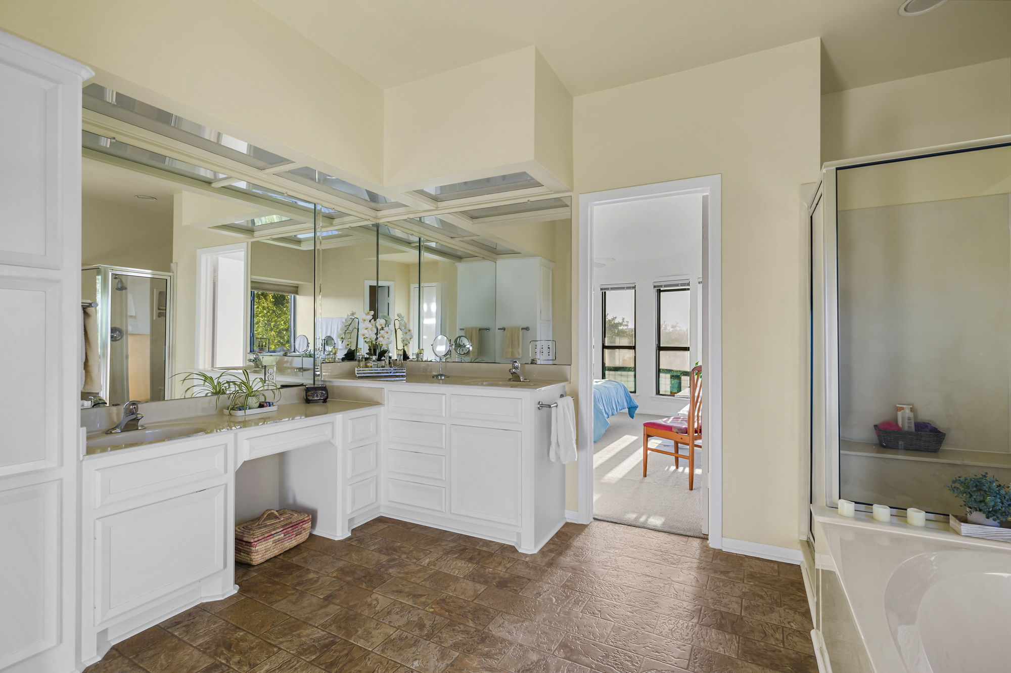 1605 The High Road Austin, TX 78746 - Photo 28 of 45 a large white kitchen with a lot of white cabinets and stainless steel appliances