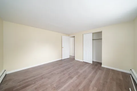 a view of an empty room and wooden floor