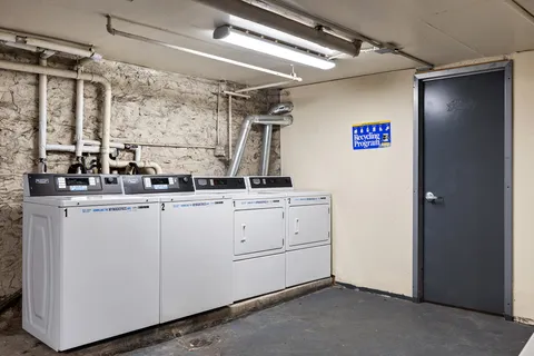 a room with white cabinets and window