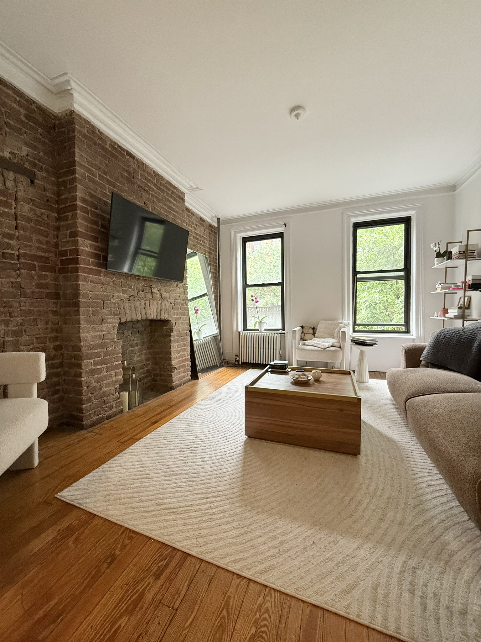 317 East 73rd Street, Unit 3FE Manhattan, NY 10021 - Photo 1 of 6 a living room with furniture and a fireplace
