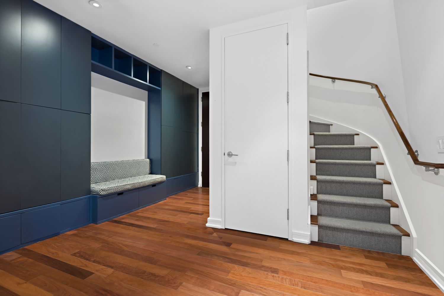 101 Warren Street, Unit 11L Manhattan, NY 10007 - Photo 11 of 26 a view of an empty room with wooden floor and stairs