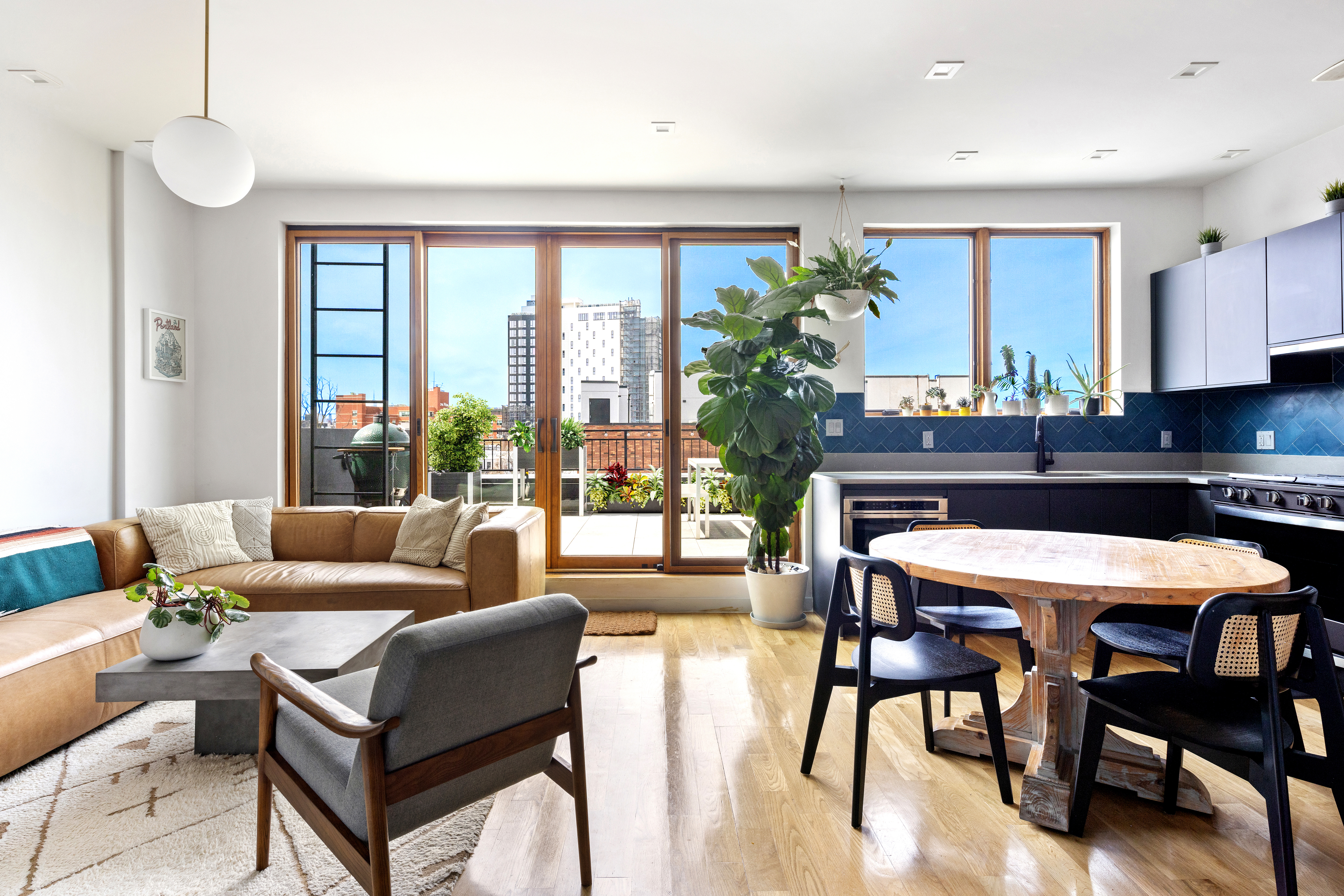 64 Stanhope Street, Unit PH Brooklyn, NY 11221 - Photo 1 of 13 a living room with furniture and a large window