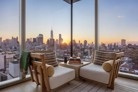 a view of roof deck with seating space and a chairs