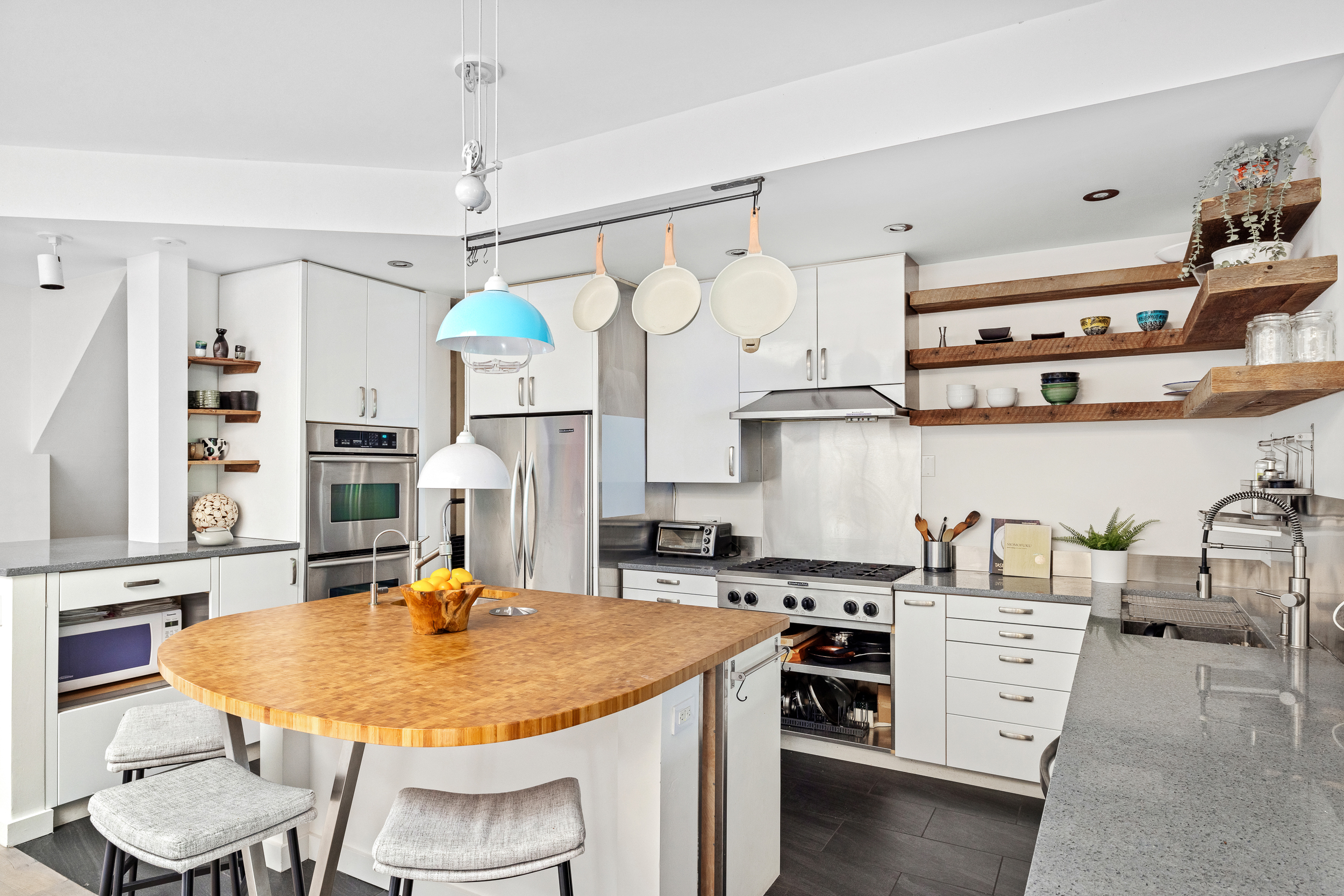 65 Jackson Street Brooklyn, NY 11211 - Photo 10 of 36 a kitchen with stainless steel appliances granite countertop a sink a stove and a wooden floor