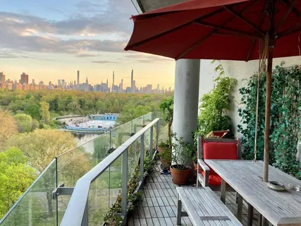 a view of a balcony with chairs and wooden floor
