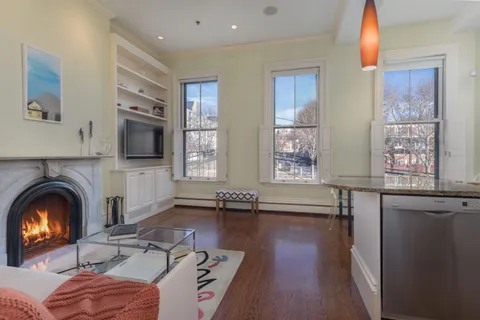 a living room with furniture fireplace and flat screen tv
