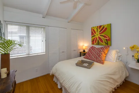 a bedroom with a bed and a window