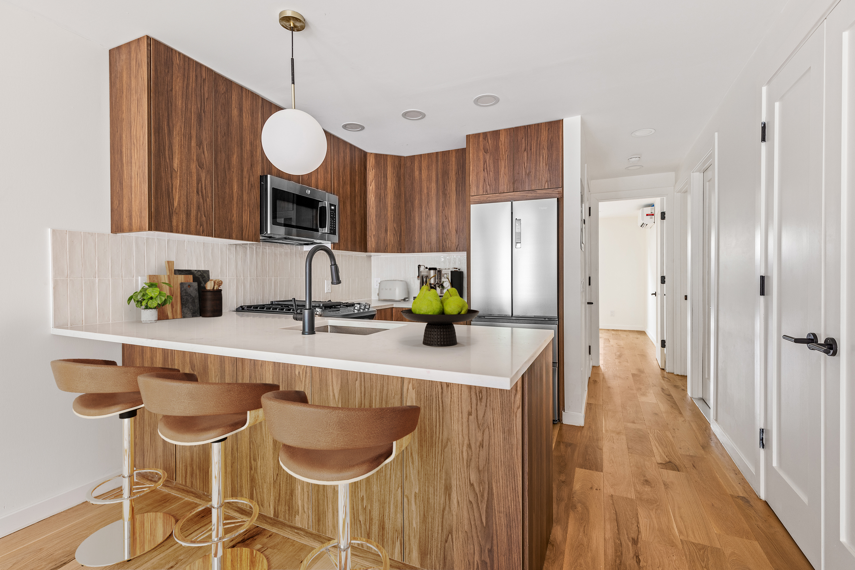 95 Moffat Street Brooklyn, NY 11207 - Photo 16 of 18 a kitchen with wooden cabinets and center island