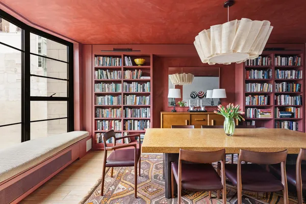 a dining room with furniture and a window