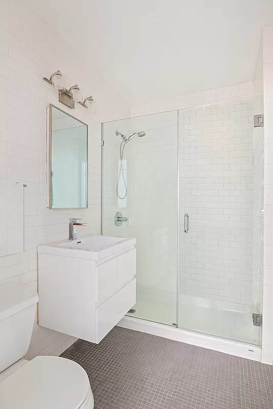 4 Water Street, Unit 2C Brooklyn, NY 11201 - Photo 12 of 21 a bathroom with a sink a toilet and shower