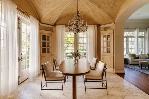 a dining room with furniture and wooden floor