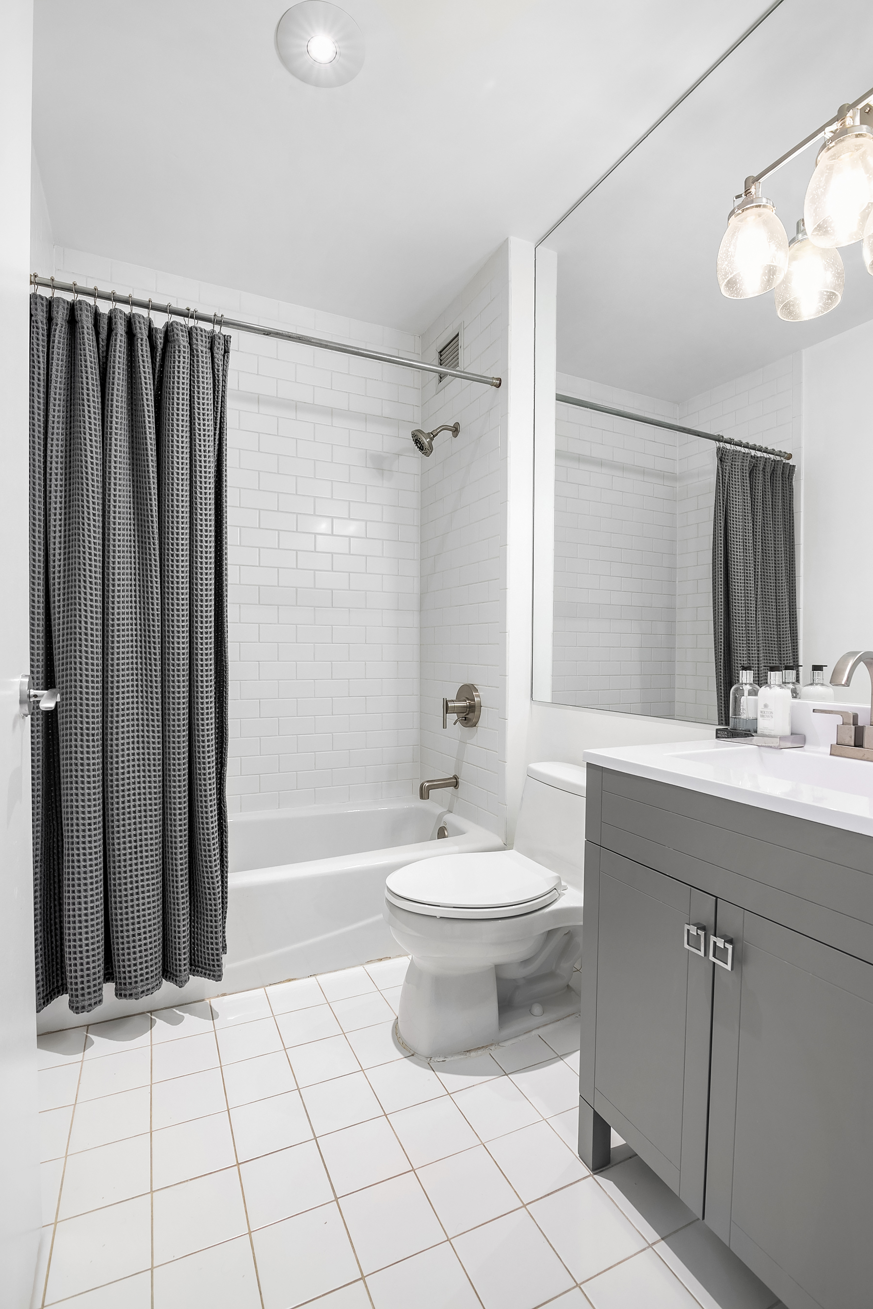 32 West 128th Street, Unit 4 Manhattan, NY 10027 - Photo 10 of 11 a bathroom with a sink a toilet and shower