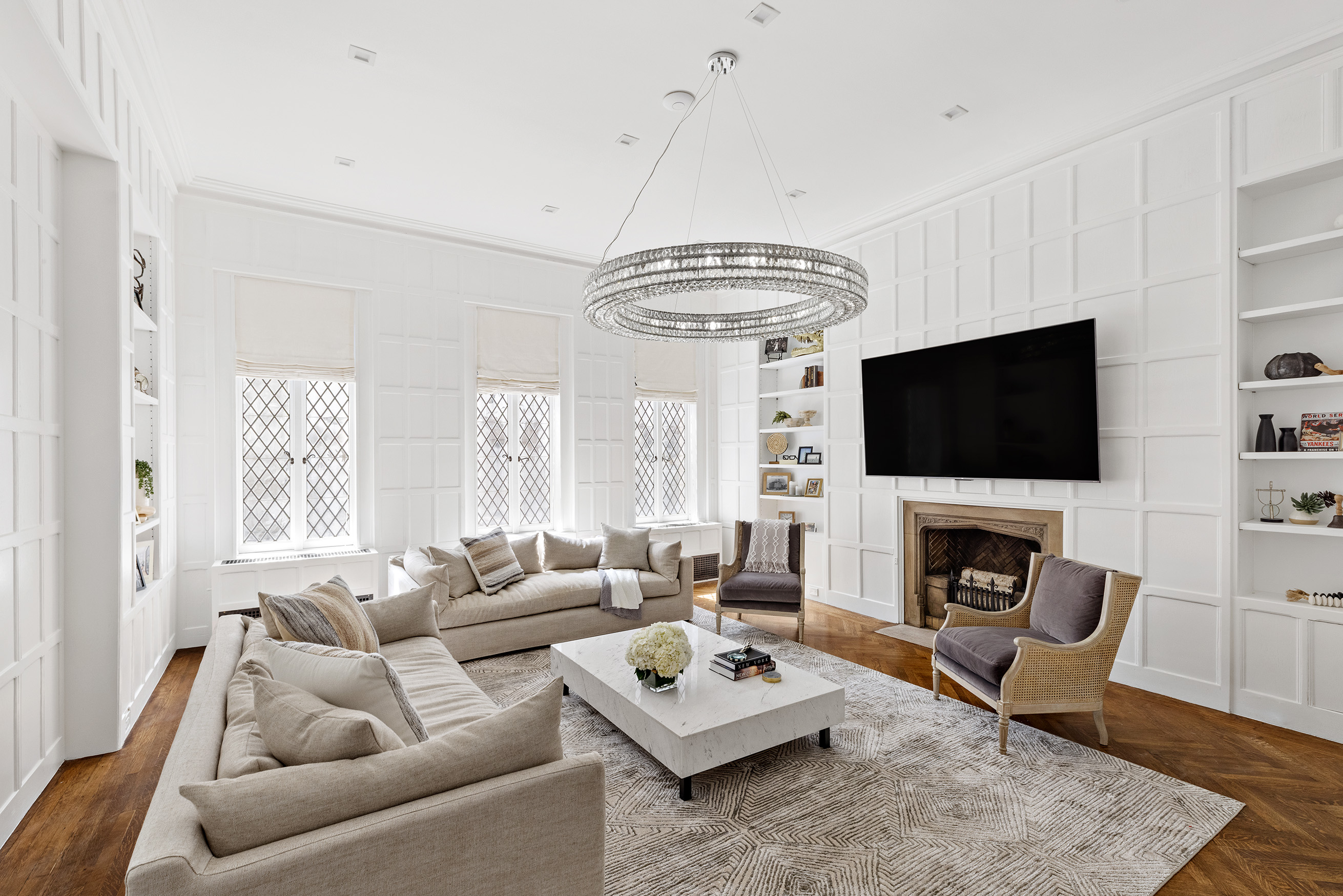25 East 94th Street Manhattan, NY 10128 - Photo 2 of 33 a living room with furniture a flat screen tv and a fireplace