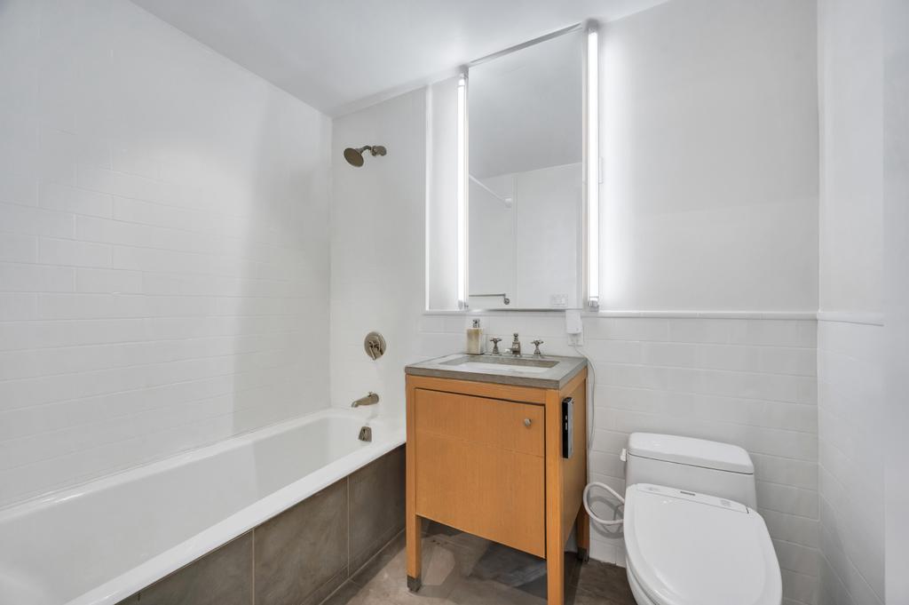 2628 Broadway, Unit 15B Manhattan, NY 10025 - Photo 12 of 21 a bathroom with a toilet a sink and bathtub