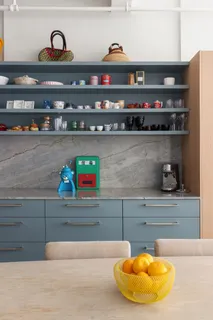 a kitchen sink with stainless steel appliances and cabinets