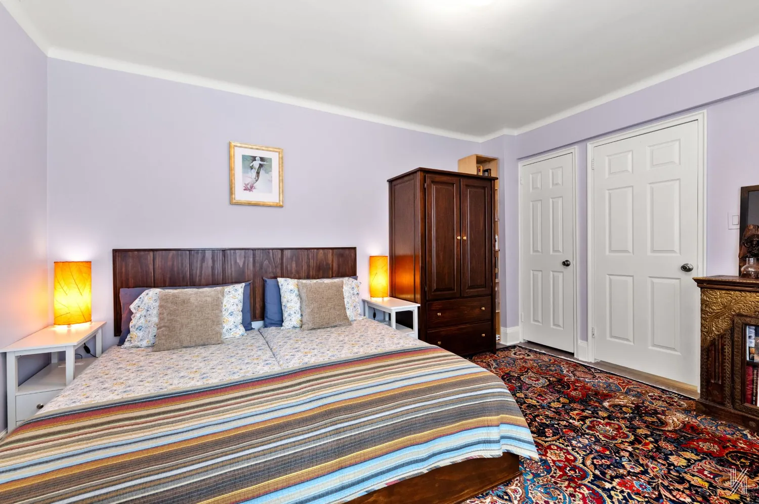 a bedroom with a bed and a television