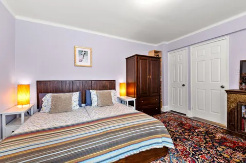 a bedroom with a bed and a television