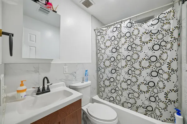 a bathroom with a sink toilet and shower