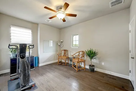 a view of a room with gym equipment and windows