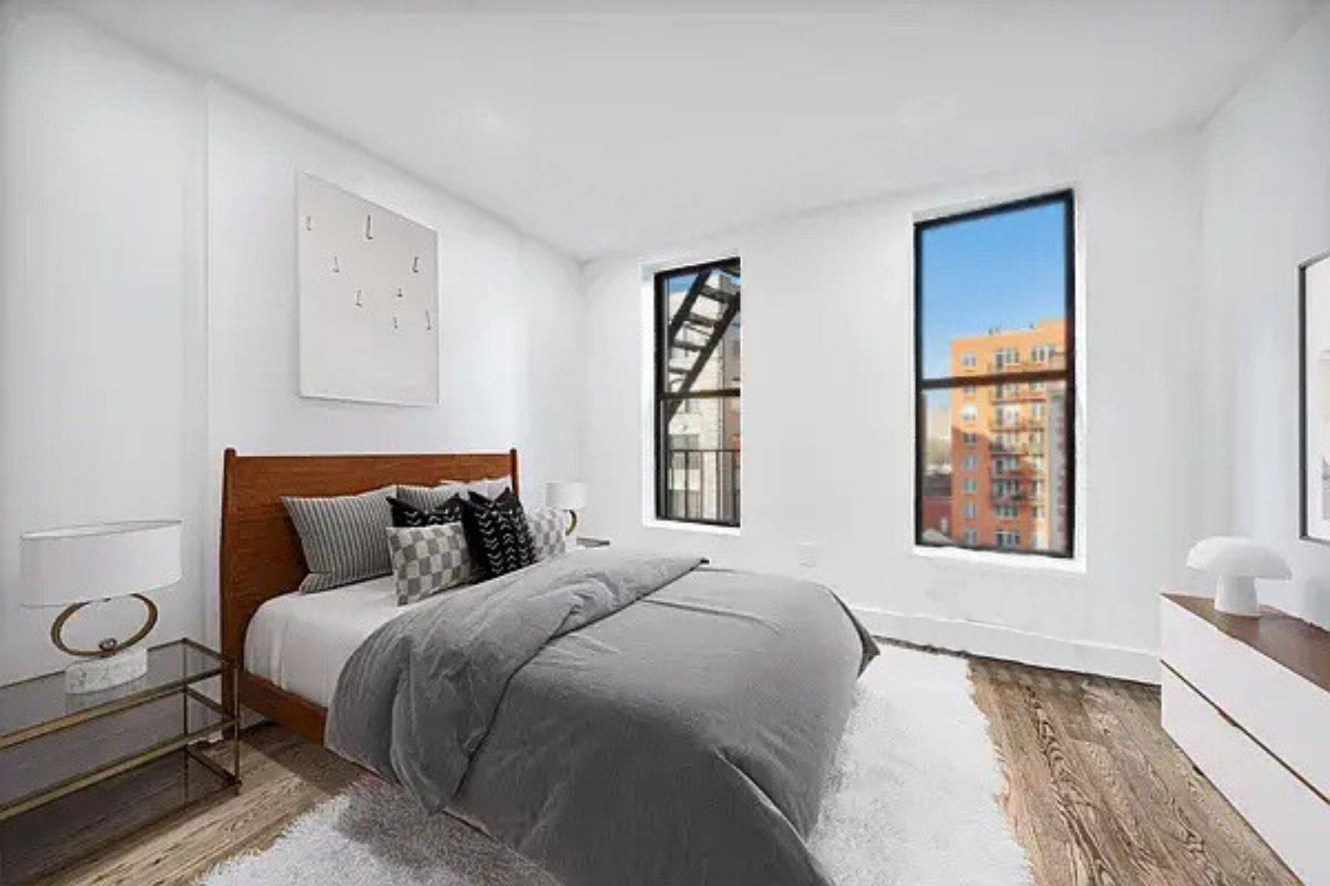 66 West 138th Street, Unit 3A Manhattan, NY 10037 - Photo 6 of 8 a bedroom with a bed and a window