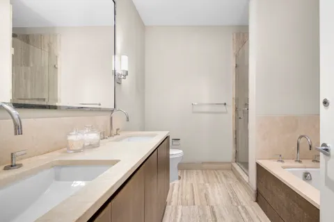 a bathroom with a sink a vanity and a large mirror