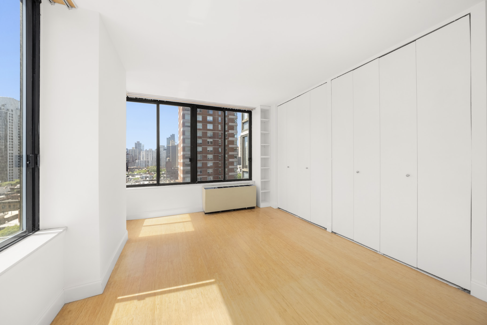300 East 93rd Street, Unit 18E Manhattan, NY 10128 - Photo 9 of 15 a view of an empty room with a window