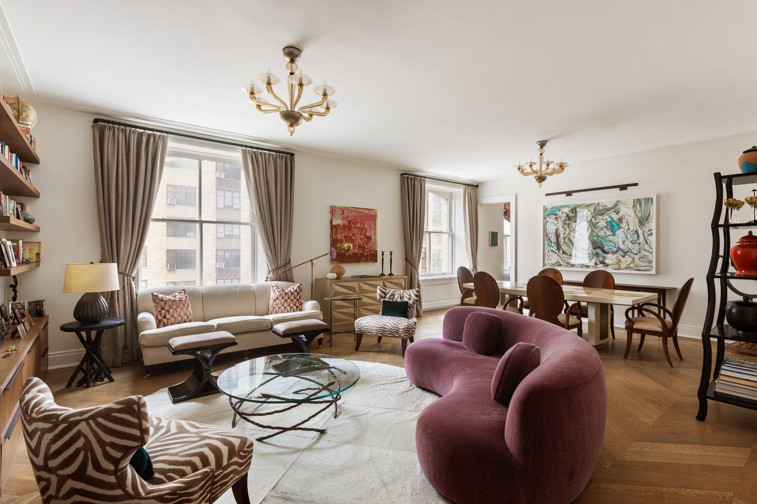 a living room with furniture chandelier and a large window
