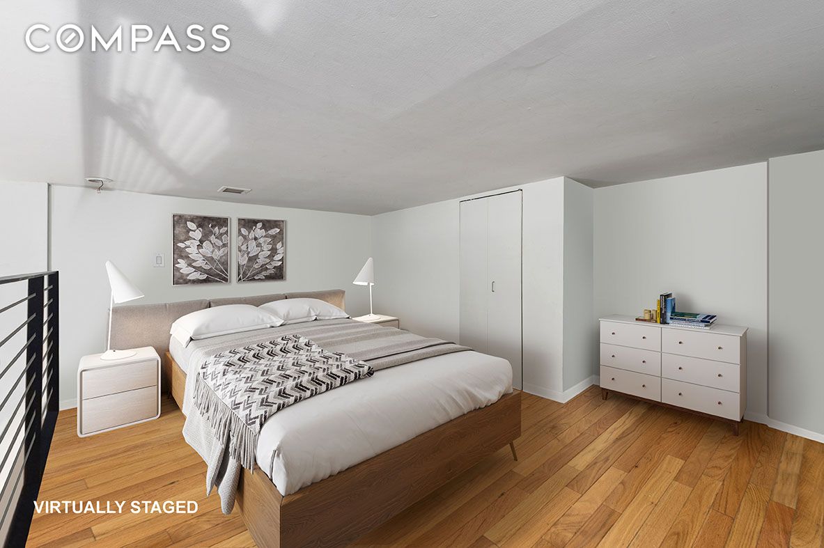 184 Thompson Street, Unit 1E Manhattan, NY 10012 - Photo 5 of 8 a bedroom with a bed and a desk