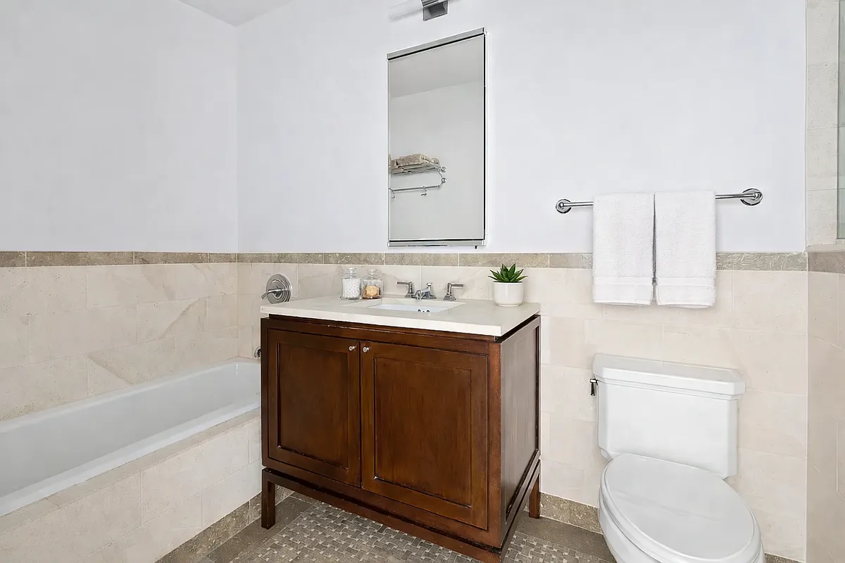 1 Hanson Place, Unit 15C Brooklyn, NY 11243 - Photo 5 of 8 a bathroom with a sink and a mirror