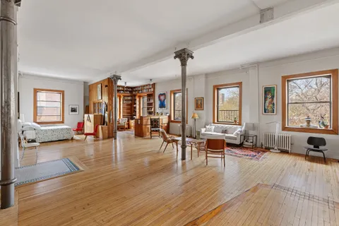 a living room with furniture window and wooden floor