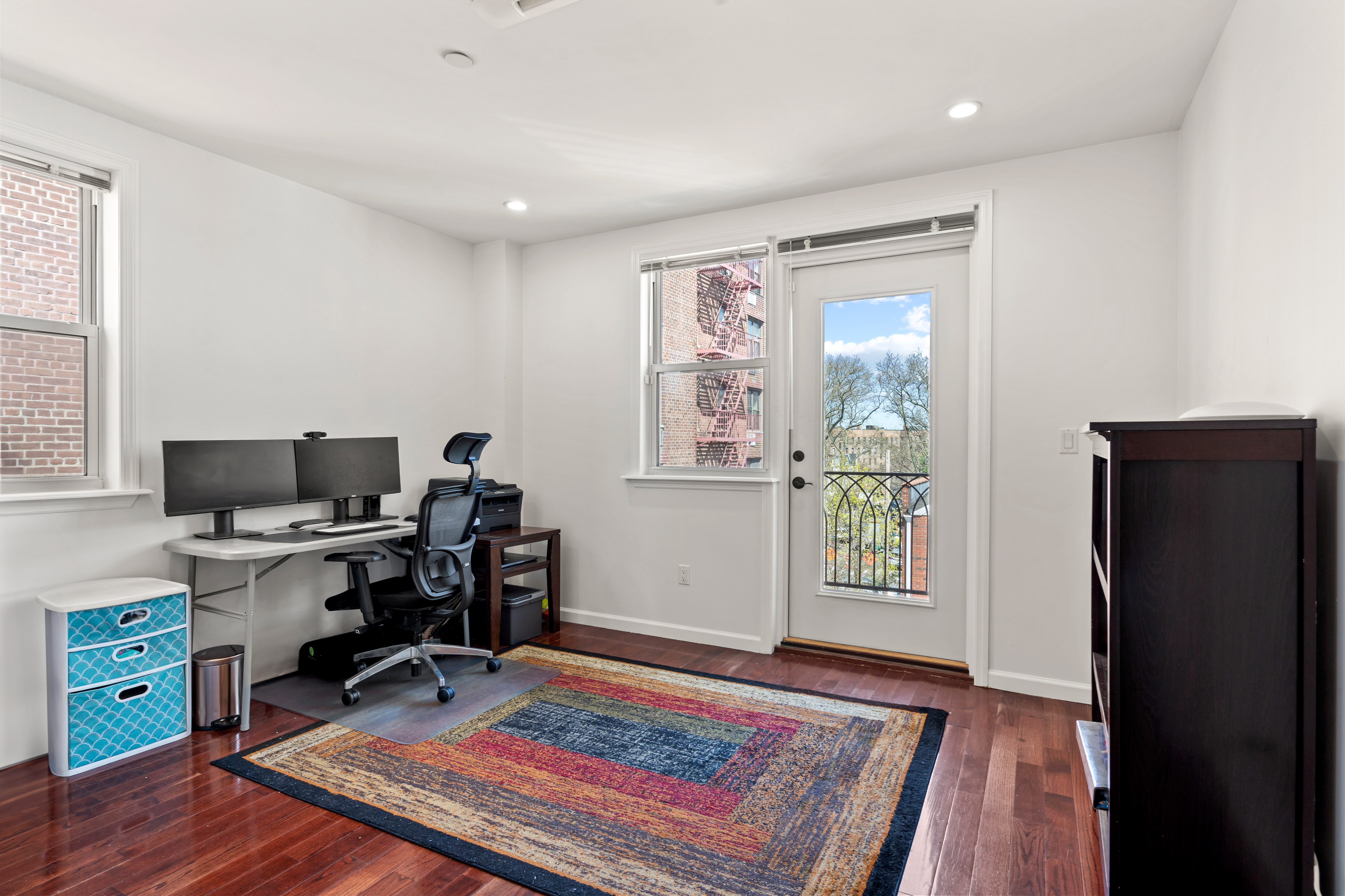 65-33 38th Avenue, Unit 5 Queens, NY 11377 - Photo 10 of 23 a view of a workspace with furniture and a window